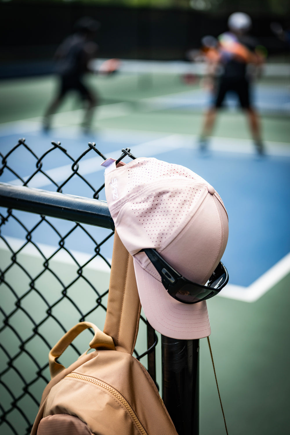 Sunglasses slide off hats because hats were never designed to hold them. The result?